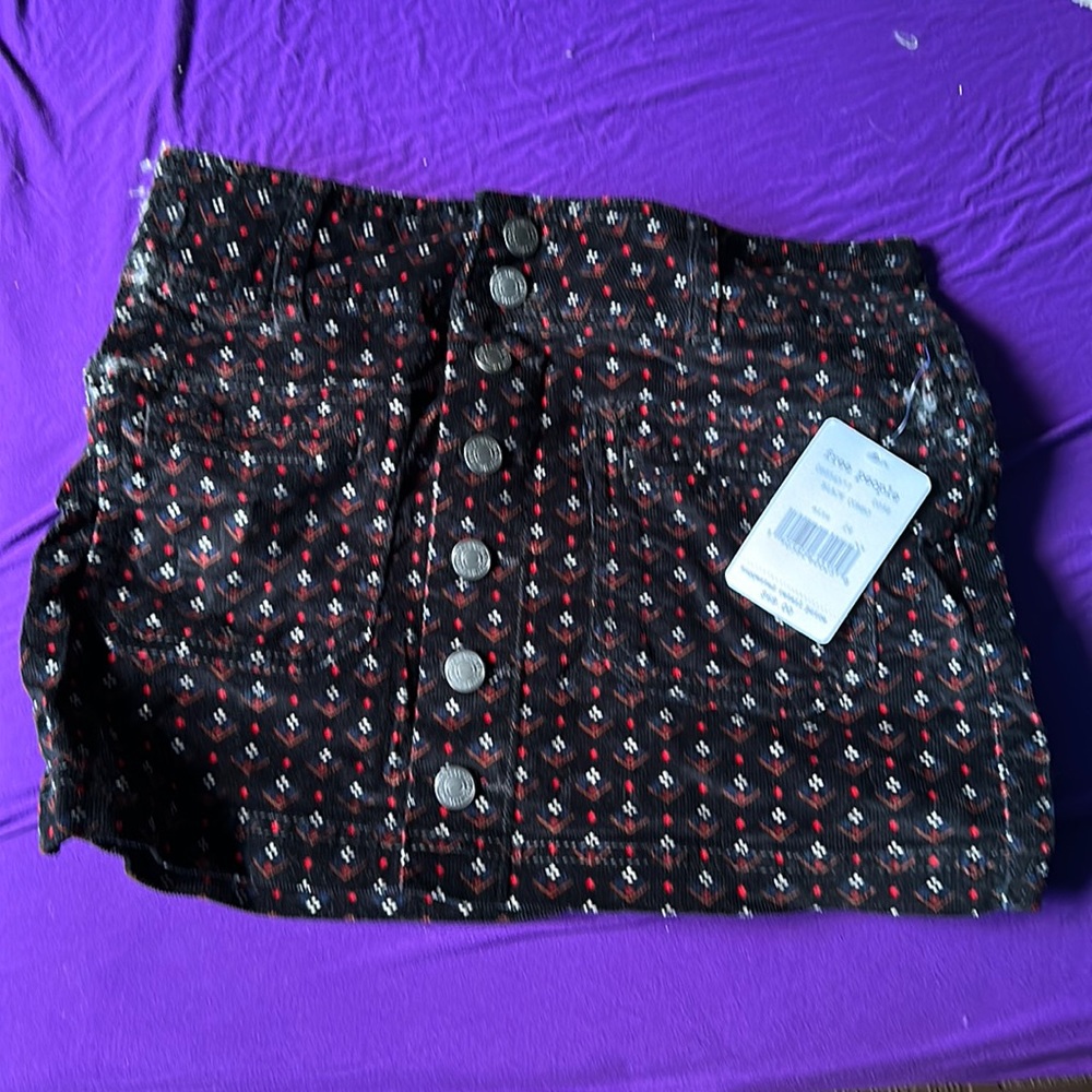 Free people skirt. Black with red print. Size 24.